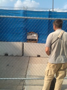 Photographer at a Hole in the Fence at Light & Lee