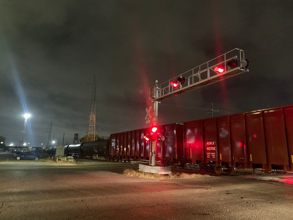A train stalled on the tracks in the dark.